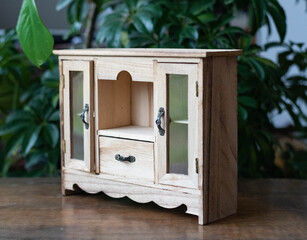 Miniature cabinet - small doll furniture on a wooden table