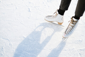 Figure skating on a frozen lake in a park with blade marks. Snowy day