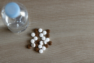 Above view of medicines and bottle of water.