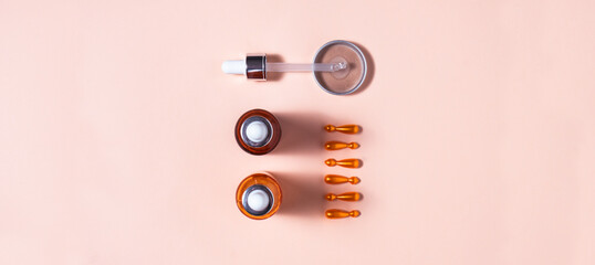 Q 10, retinol, vitamin C, collagen, hyaluronic acid and salicylic acid face serum and ampoules , top view mockup composition with copy space on pink background