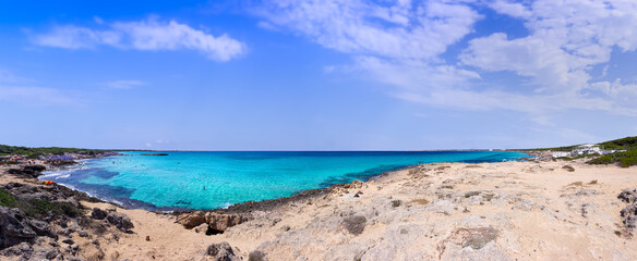 Punta della Suina beach in Salento, Apulia. Italy. It's surrounded by the Mediterranean scrub and by pine forest, boasts two small sandy bays and a small islet, which is almost separated by coast.