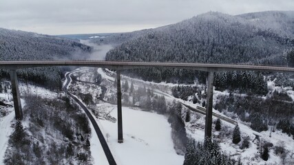 Bridge crossing snow covered valley