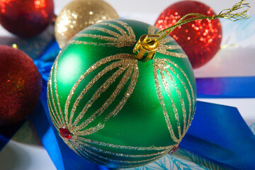 Fototapeta na wymiar Happy Christmas. Multicolored balls on the blue and white gift