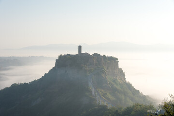 It is a village of Civita di Bagnoregio in Lazio, Italy. Surrounded by the sea of clouds in the morning, it is a fantastic landscape.