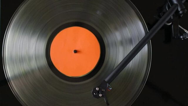 Close up of turntable tonearm playing vinyl record
