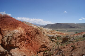 An unusual natural area in the Altai mountains with colored soil similar to the Martian landscape. Natural attraction of Altai. Popular tourist routes in Russia.