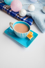 Fototapeta na wymiar Coffee in a blue striped set and cubes of cane sugar in the New Year scenery