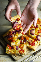 Fresh homemade focaccia with blue onions and cherry tomatoes.