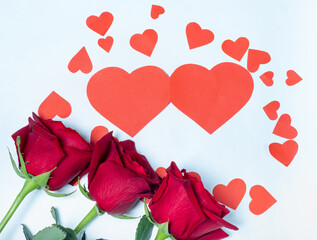 Roses and card for Valentine's Day in the form of a heart on a white background. Background for valentine's day. Top view.