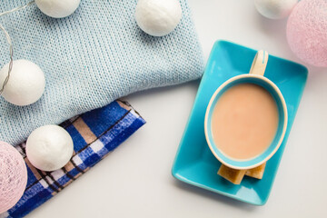 Fototapeta na wymiar Coffee in a blue set and cubes of cane sugar in the New Year scenery