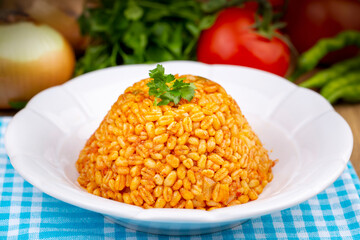 Traditional turkish bulgur pilaf with tomato sause in plate (Turkish name; meyhane pilavi)