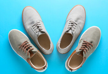 Casual male shoes on color background