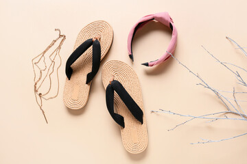 Stylish female flip-flops and  accessories on light background