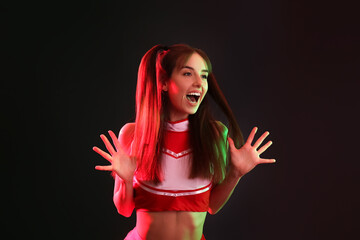 Emotional cheerleader on dark background