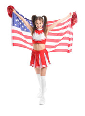 Beautiful young cheerleader with USA flag on white background