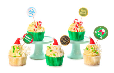 Tasty Christmas cupcakes on white background
