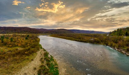 Flight over autumn mountain river