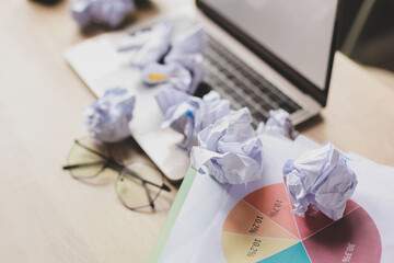Many of crumpled paper ball on the messy office table. Business Creativity Concept