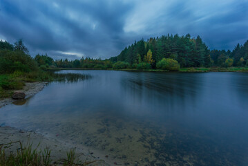Small forest lake on a cloudy night, inBelarus