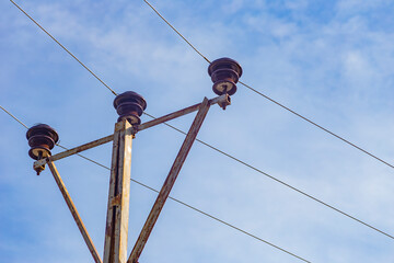 Electrical pole and line with sky.