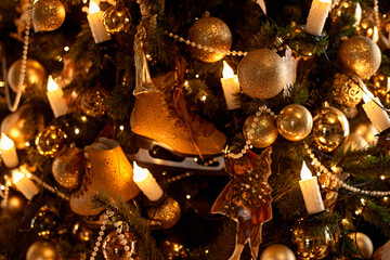 Close up of a decorated Christmas Tree with colourful decorations and garland lights, bokeh. Festive and New Year concept.