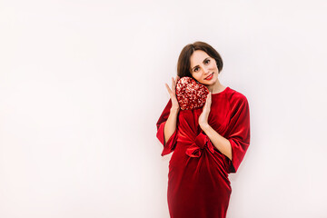 Fototapeta premium Valentines day. Portrait pretty woman in red dress with heart in hands.