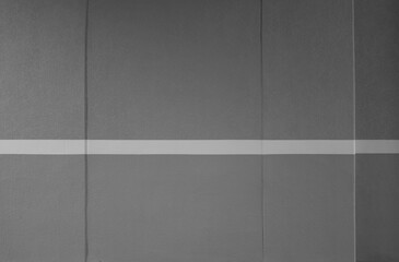 Gray concrete wall with white lines.