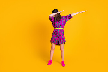 Full size photo of brunette pretty girl wearing pink dress black headwear dancing showing hype dab sign isolated on yellow color background