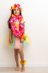 little girl in hawaiian costume isolated white background