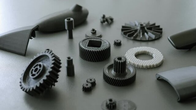 Close-up on the table are plastic models printed on a 3D printer in a scientific laboratory. 3d printing in action.