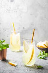Melon juice, lemonade in glasses with ice and melon slices garnished with basil leaves. Concept of fresh summer drink