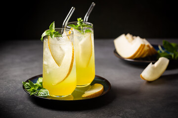 Melon juice, lemonade in glasses with ice and melon slices garnished with basil leaves. Concept of...