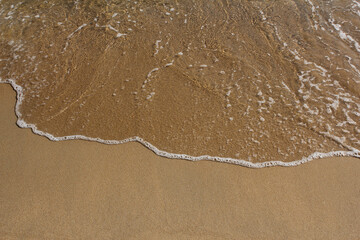 brown Sand beach and Wave foam.