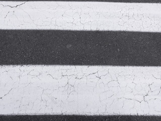 Old Asphalt crosswalk close up.