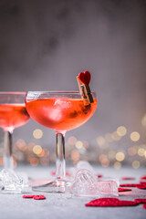 Festive pink cocktail with champagne or prosecco  for St. Valentine's day. Couple of glasses