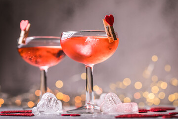 Festive pink cocktail with champagne or prosecco  for St. Valentine's day. Couple of glasses
