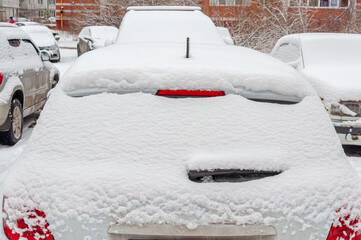 Cars covered with a thick layer of snow