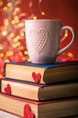 Stack of books and red heart. Romantic background with the book