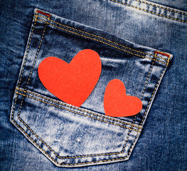 Red hearts on denim. Love symbol. Valentine's card.