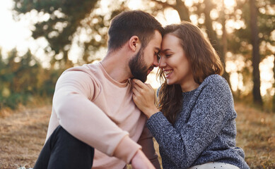 Closeness of the people. Cheerful lovely young couple having a rest outdoors together