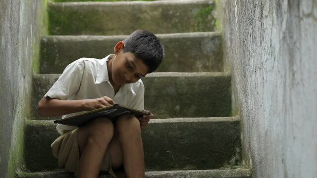 Cute indian child studying at home