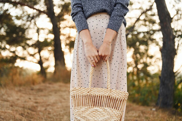 Young woman have a walk outdoors in the forest at sunny daytime