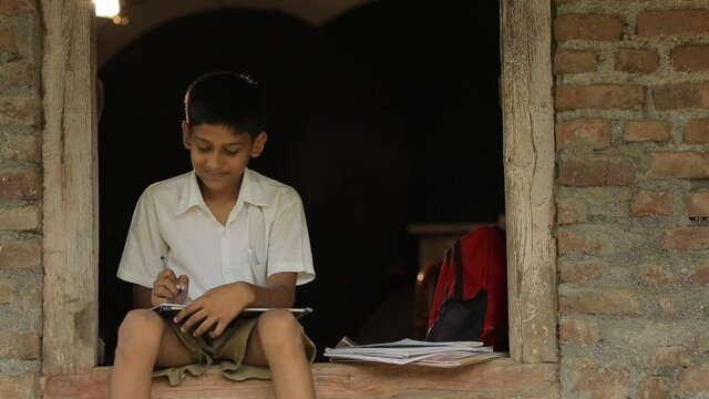 Cute indian child studying at home