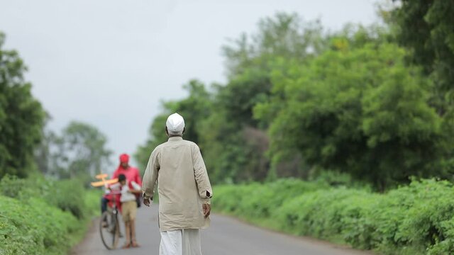 Cute indian school child going to school with his father on cycle