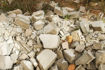 Construction debris on site with broken panels and bricks, closeup view. Construction dump with...