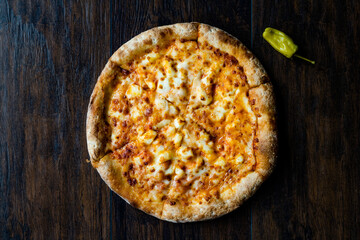 Pizza Quattro Formaggi Four Cheese Pizza on Wooden Surface.