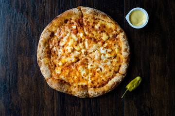 Pizza Quattro Formaggi Four Cheese Pizza on Wooden Surface.