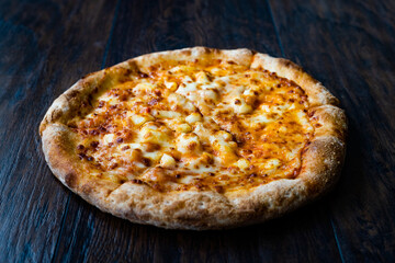 Pizza Quattro Formaggi Four Cheese Pizza on Wooden Surface.