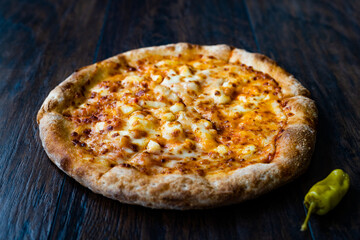 Pizza Quattro Formaggi Four Cheese Pizza on Wooden Surface.