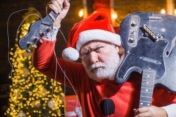 New year. Bad Santa. Santa Claus with broken guitar. Santa costume. Christmas time. Christmas....